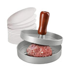Hamburgerpress med separeringspapper och formad burgare